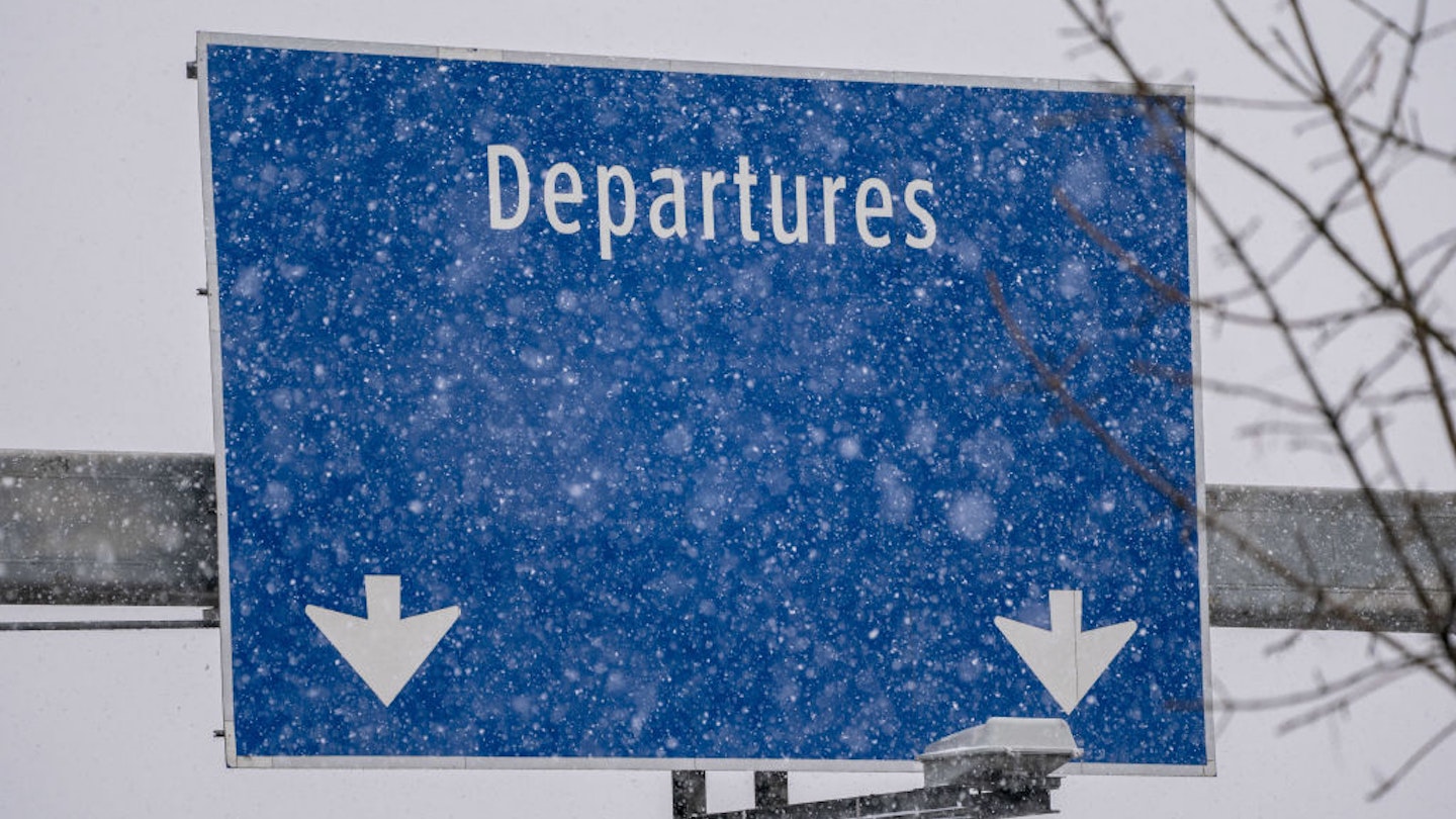 A "Departures" sign during a snow storm at Seattle-Tacoma International Airport (SEA) in Seattle, Washington, US, on Tuesday, Dec. 20, 2022. An estimated 112.7 million people will travel 50 miles or more from Dec. 23 to Jan. 2, up by 3.6 million from last